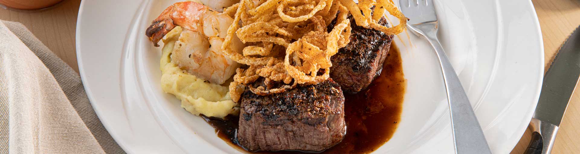 Filet Medallions <span class=”d-inline-block”> and Shrimp</span>
